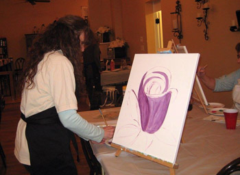 Taste & Paint guest working on a painting